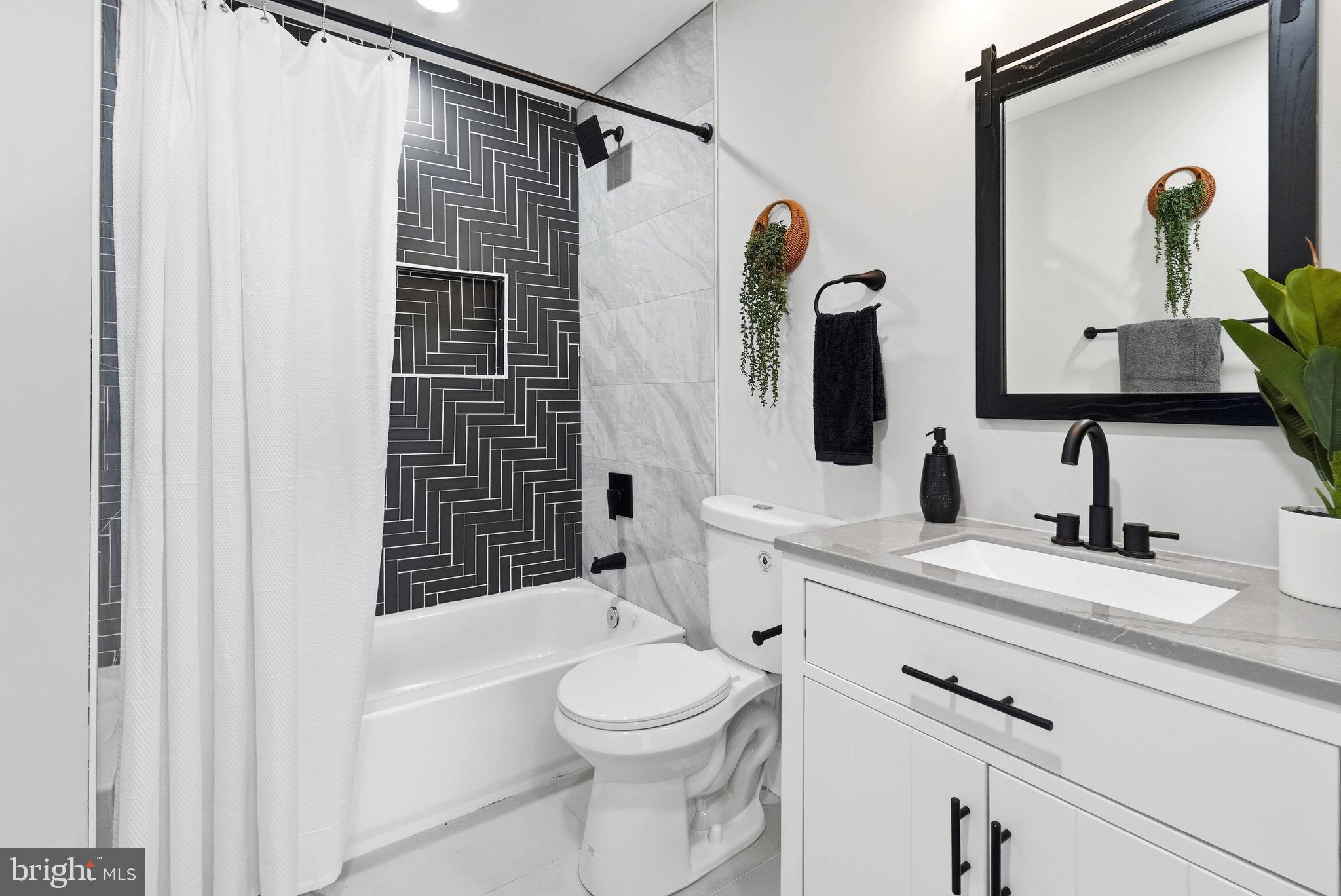 2237 Madison Avenue Baltimore, MD 21217 - Photo 48 of 53 a bathroom with a toilet sink and mirror