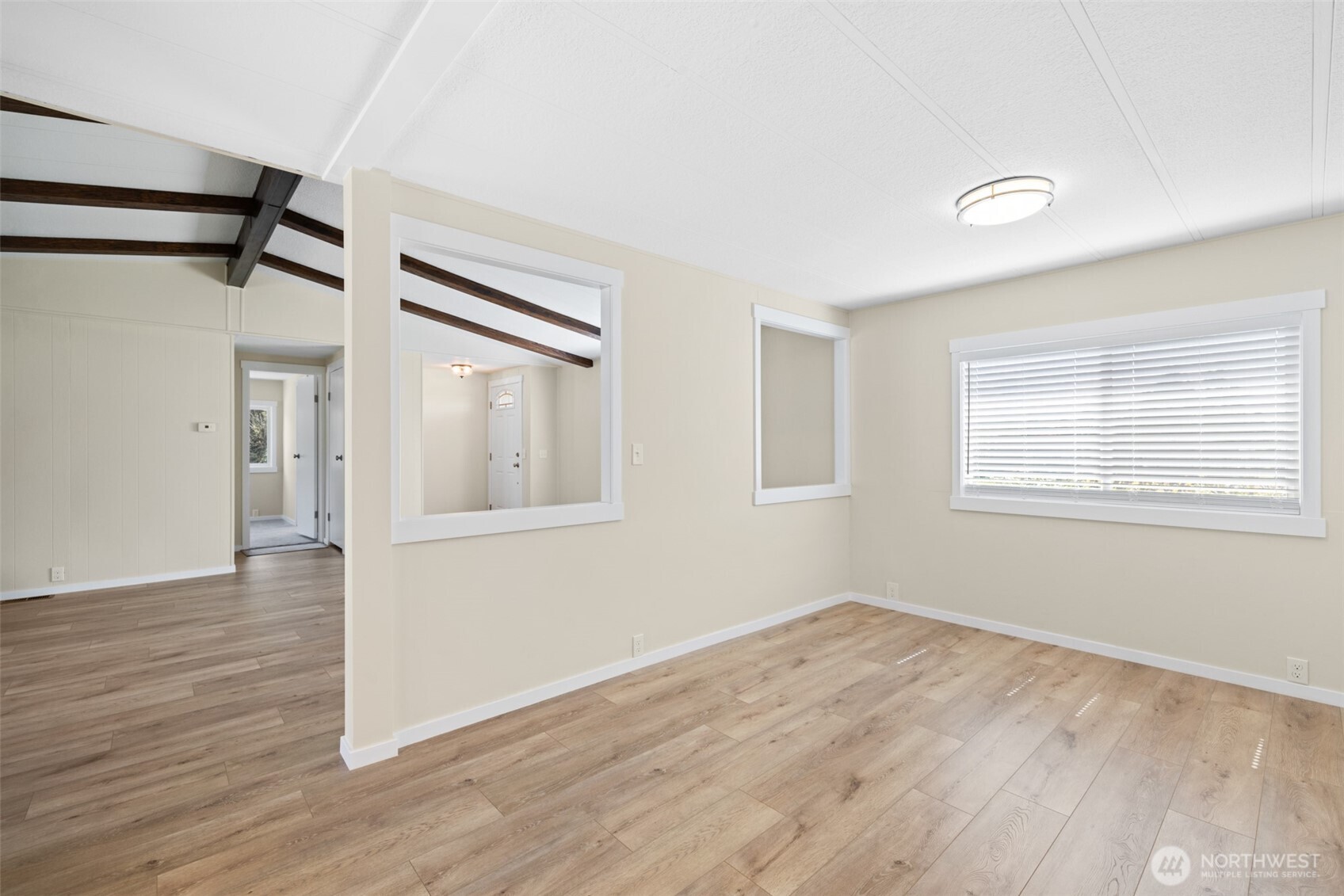 360 Mountain View Drive Sequim, WA 98382 - Photo 12 of 39 a view of an empty room with wooden floor and a window