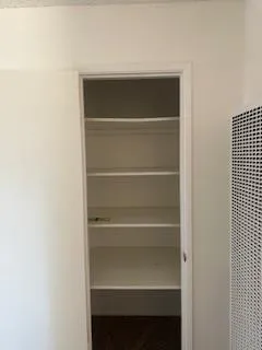 a view of walk in closet with empty racks