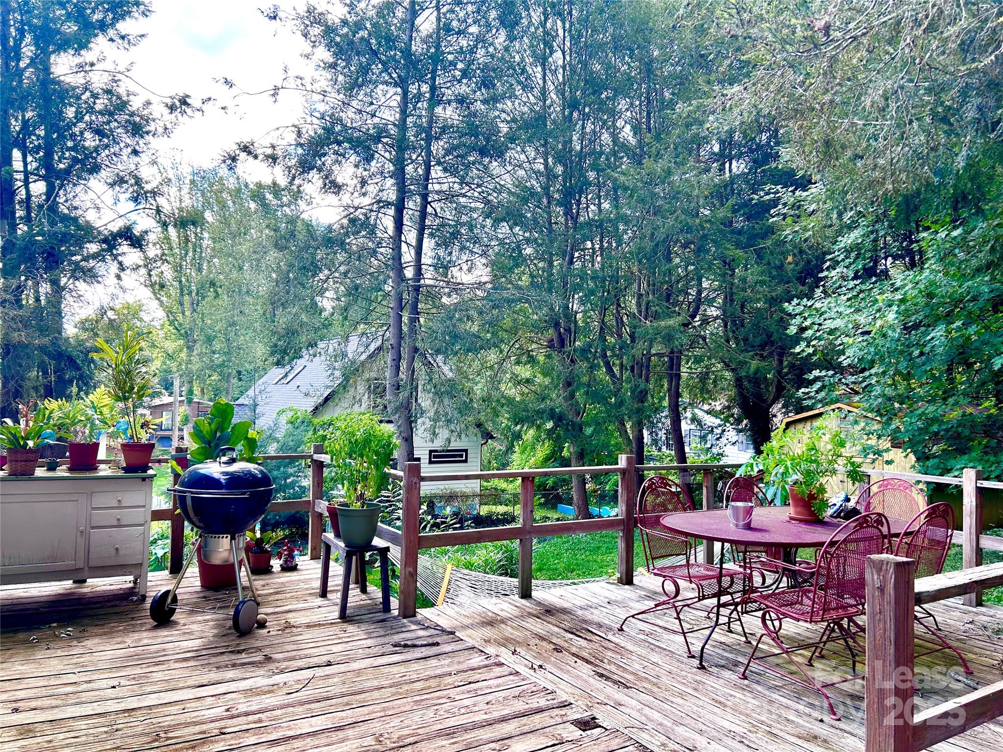 15 Pruitt Street Asheville, NC 28806 - Photo 12 of 19 a view of a table and chairs in patio with wooden fence