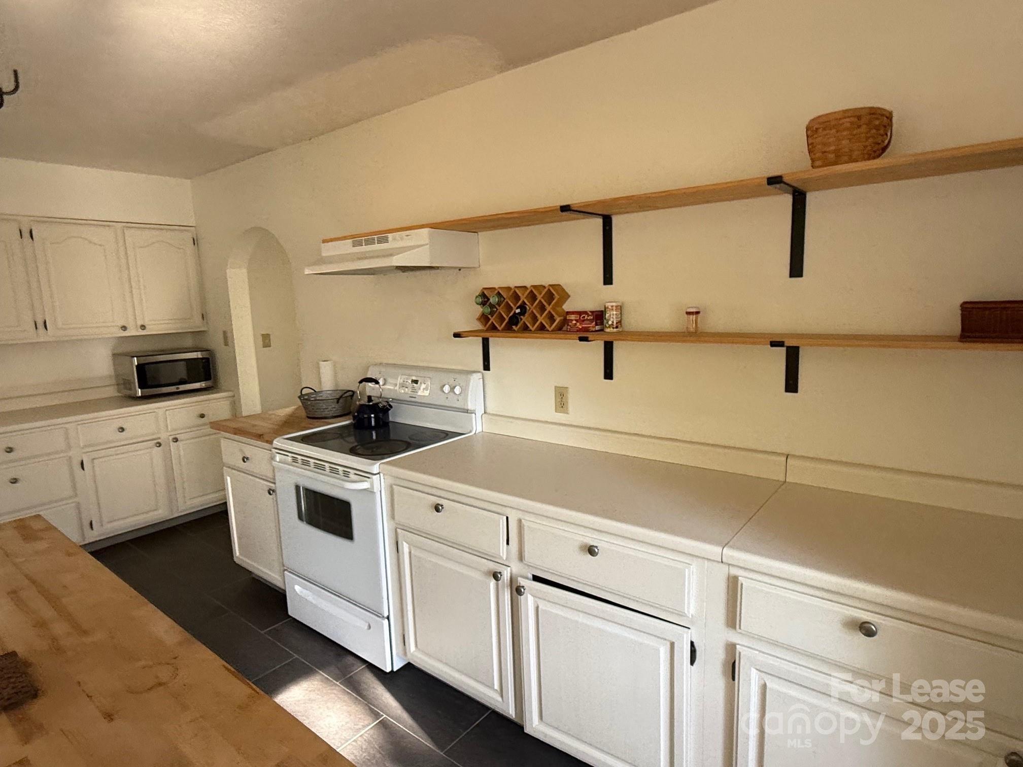 15 Pruitt Street Asheville, NC 28806 - Photo 18 of 19 a kitchen with white cabinets and white appliances