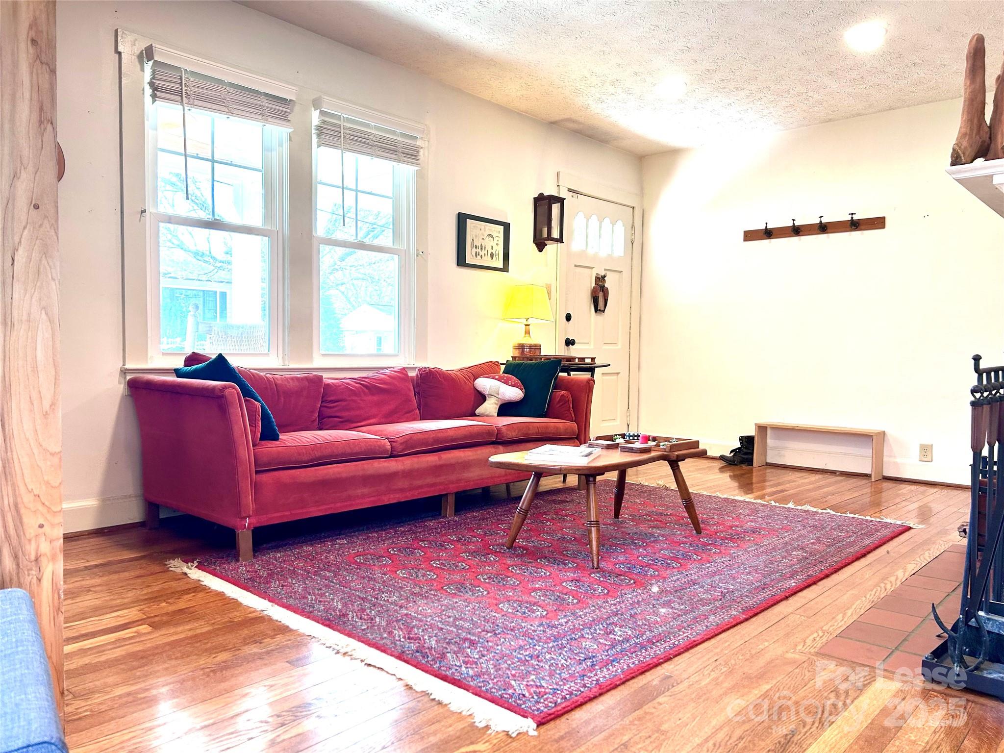 15 Pruitt Street Asheville, NC 28806 - Photo 2 of 19 a living room with furniture a rug a lamp and a table