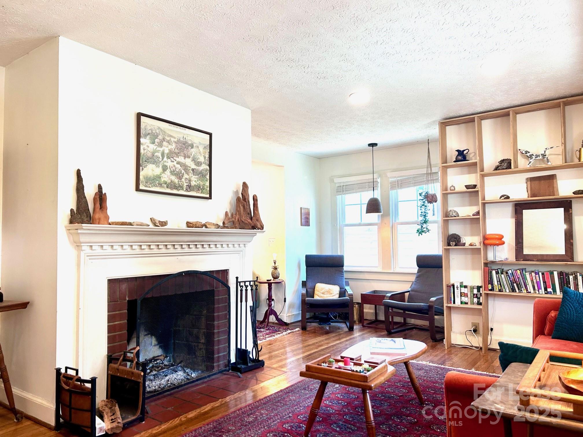 15 Pruitt Street Asheville, NC 28806 - Photo 3 of 19 a living room with furniture a fireplace and next to a window