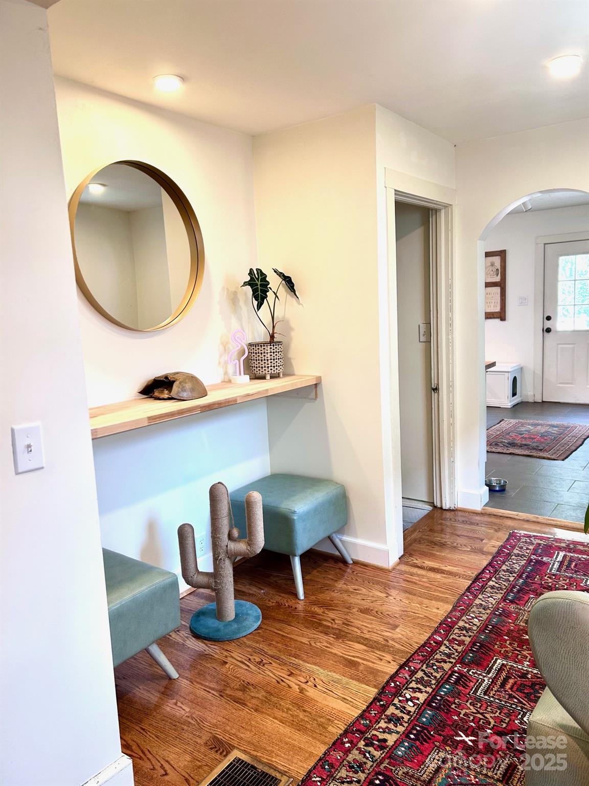 15 Pruitt Street Asheville, NC 28806 - Photo 5 of 19 a living room with chair and a mirror