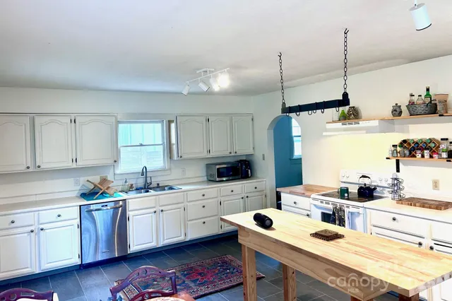 a kitchen with a sink window and cabinets