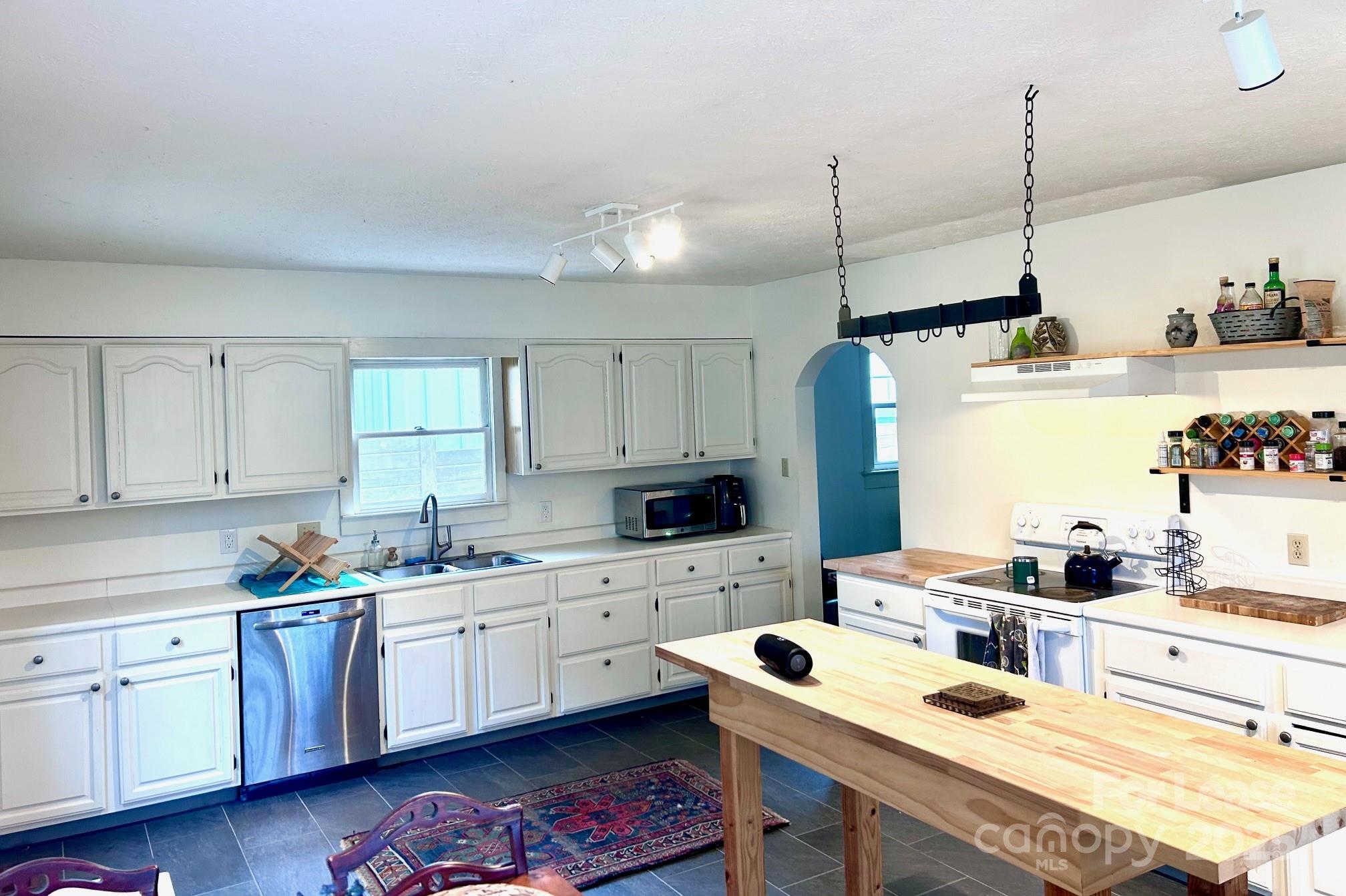 15 Pruitt Street Asheville, NC 28806 - Photo 6 of 19 a kitchen with a sink window and cabinets