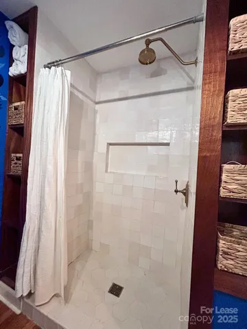 a bathroom with a shower and a tub