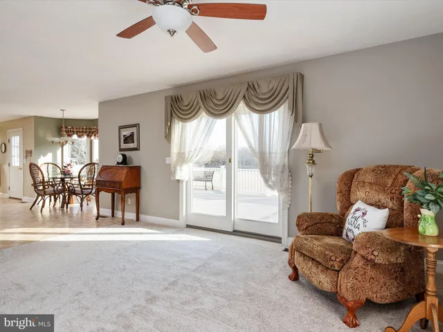 a living room with furniture and a kitchen view