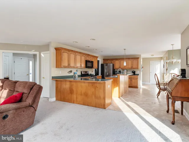 a kitchen with stainless steel appliances granite countertop a stove top oven a sink dishwasher a refrigerator and a cabinets