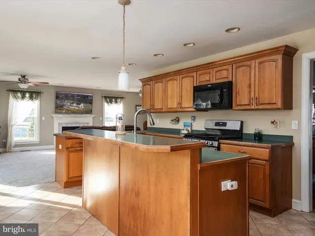 a kitchen with a table chairs sink and cabinets