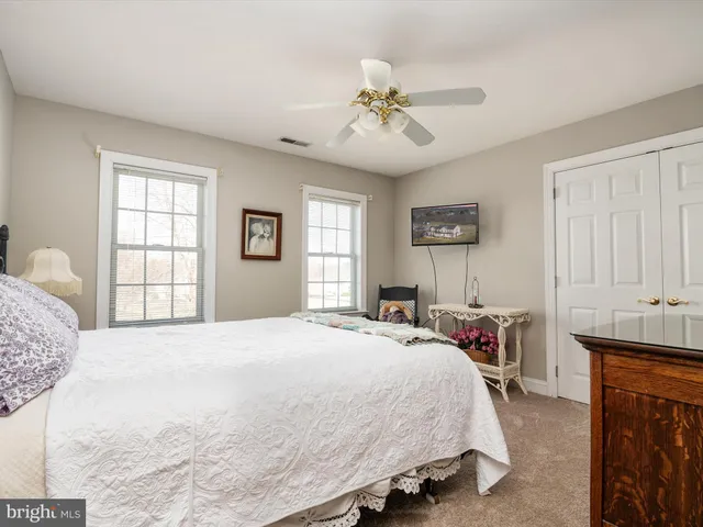 a bedroom with a bed a chair and a window