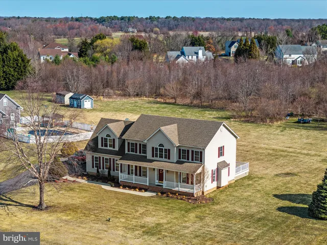 an aerial view of a house with outdoor seating