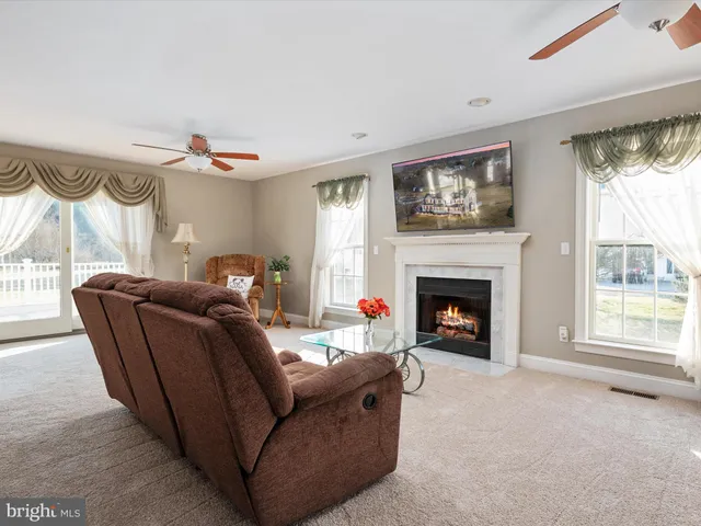 a living room with furniture a window and a fireplace