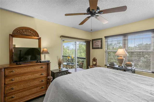a bedroom with a bed and a flat screen tv with wooden floor