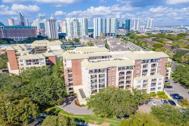 a view of a building with a garden and pathway