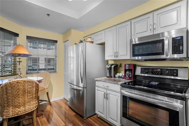 a kitchen with stainless steel appliances a stove a refrigerator and a microwave