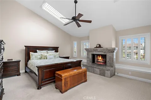 a bedroom with a bed and a fireplace