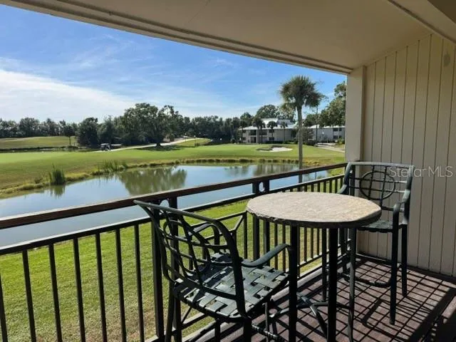 a view of a balcony with lake view and a wooden floor