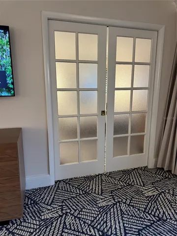 a view of a room with wooden floor and a window