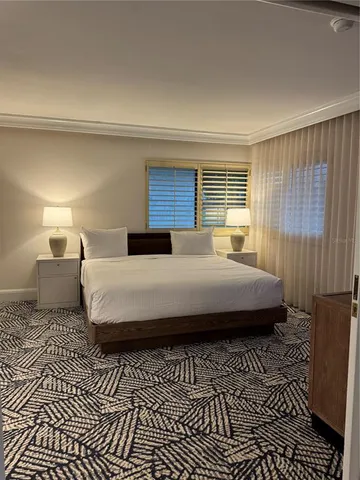 a bedroom with a bed and a night stand