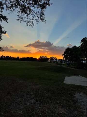 a view of a lake in front of house and outdoor seating