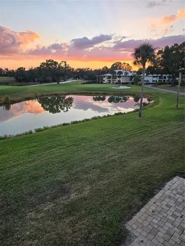 a view of a lake with houses in the back