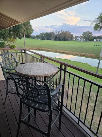 a view of a roof deck with chair and table