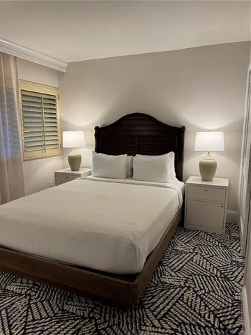 a bedroom with a bed and a lamp