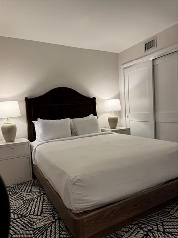 a bedroom with a bed and a walk in closet