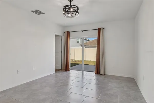 a view of an empty room and a window