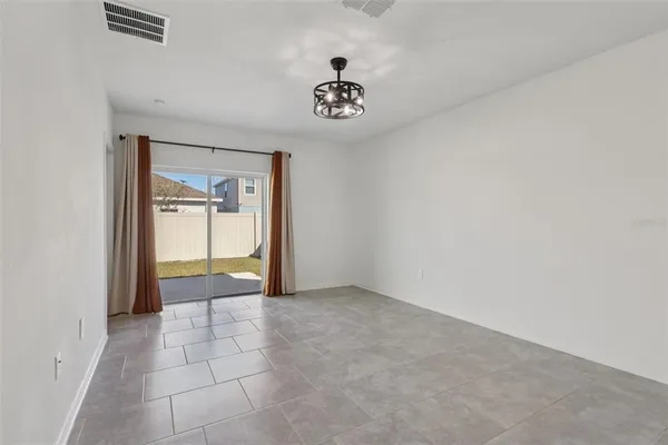 a kitchen with stainless steel appliances granite countertop a sink a stove and a microwave oven with white cabinets