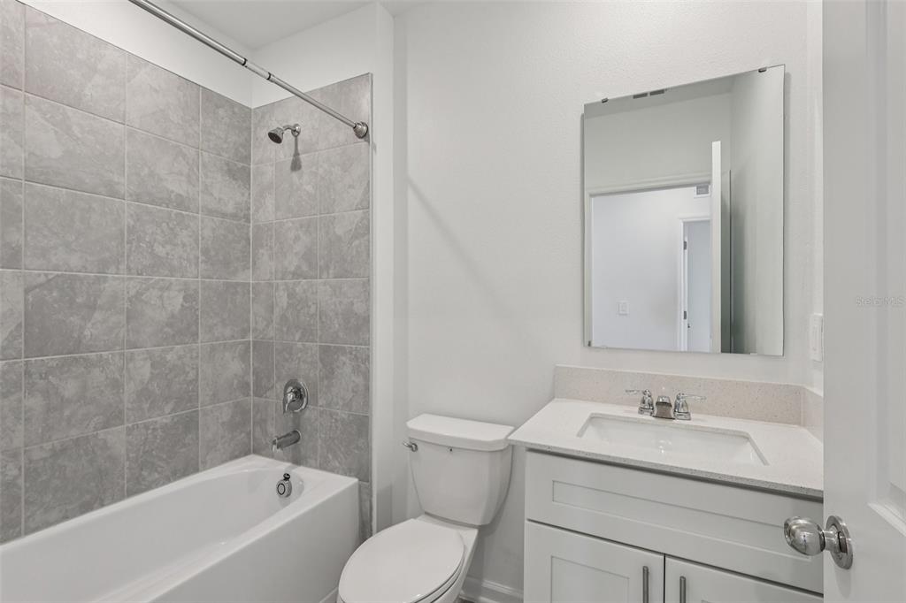 1723 Foreman Road Eagle Lake, FL 33839 - Photo 20 of 34 a bathroom with a granite countertop sink toilet and shower