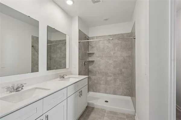 a bathroom with a shower and a sink