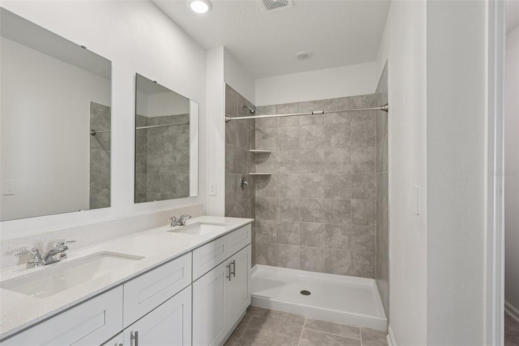 1723 Foreman Road Eagle Lake, FL 33839 - Photo 27 of 34 a bathroom with a shower sink and mirror