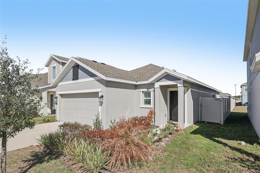 1723 Foreman Road Eagle Lake, FL 33839 - Photo 3 of 34 a front view of a house with a yard and garage