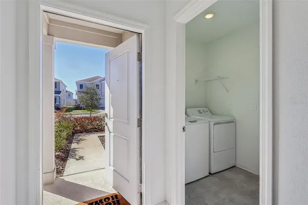 a view of an empty room with a kitchen