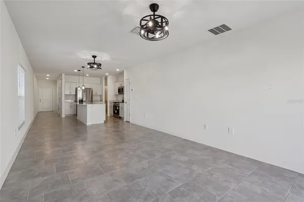 a view of a kitchen with a cabinet and a chandelier