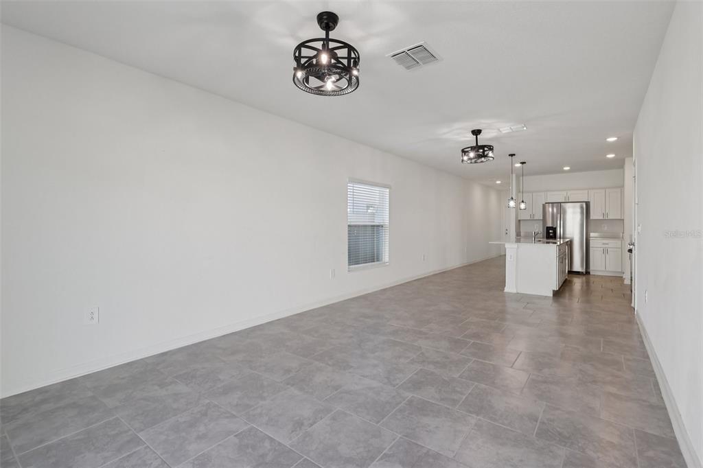 1723 Foreman Road Eagle Lake, FL 33839 - Photo 7 of 34 a view of a kitchen with a cabinet and a chandelier