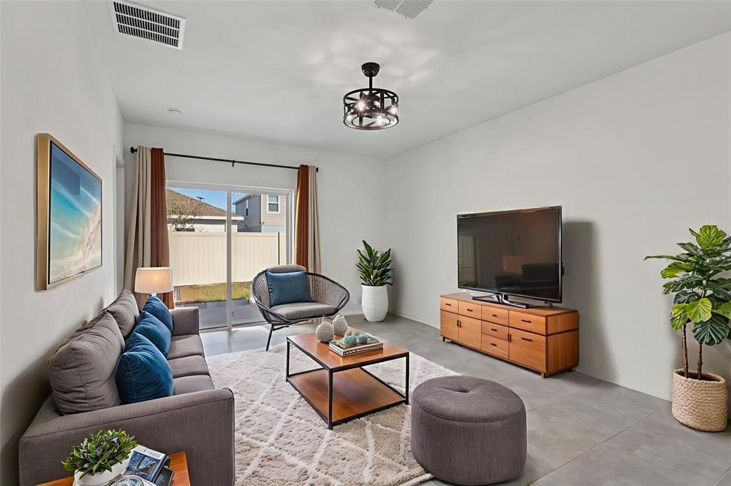 1723 Foreman Road Eagle Lake, FL 33839 - Photo 10 of 34 a living room with furniture and a flat screen tv