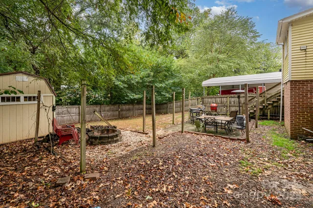 a view of a backyard with a wooden fence