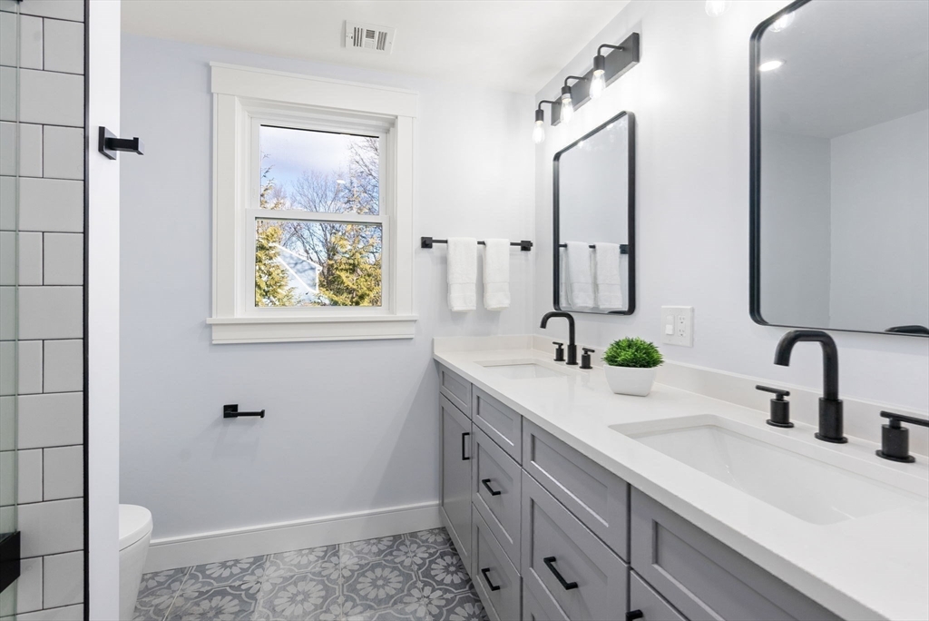 25 Geraldine Drive Wellesley, MA 02481 - Photo 18 of 24 a bathroom with a double vanity sink and a window