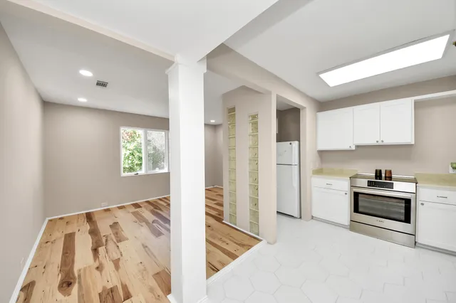 a kitchen with a refrigerator and a stove