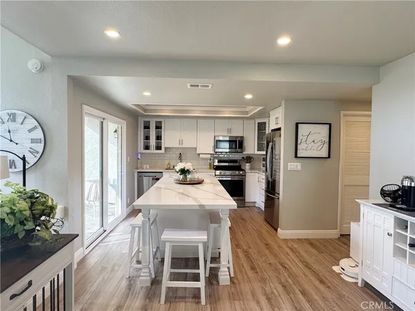 a kitchen with granite countertop stainless steel appliances and wooden cabinets