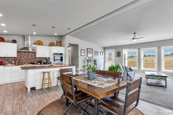 a kitchen with a table and chairs in it