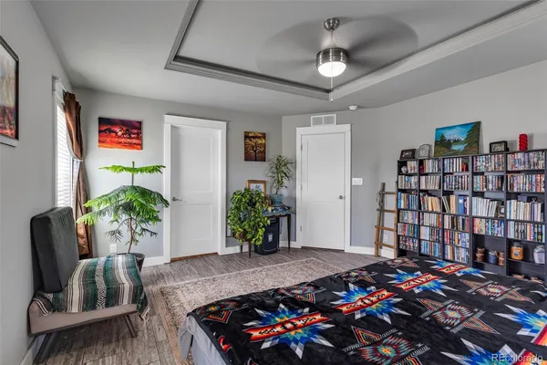 a bedroom with bed and a bookshelf