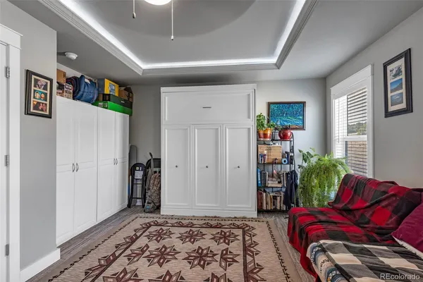 a bedroom with furniture and a rug