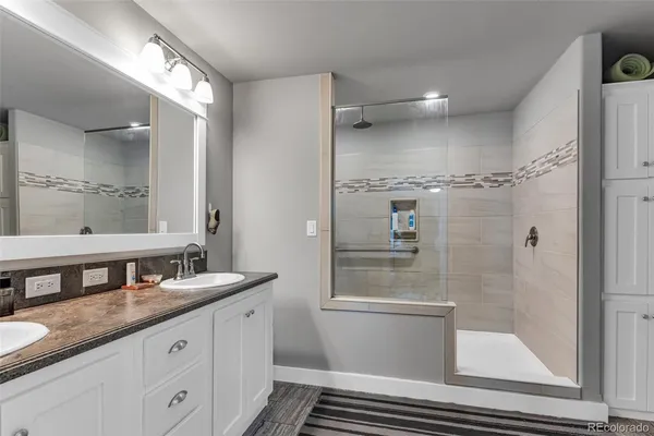 a bathroom with a granite countertop sink mirror and double