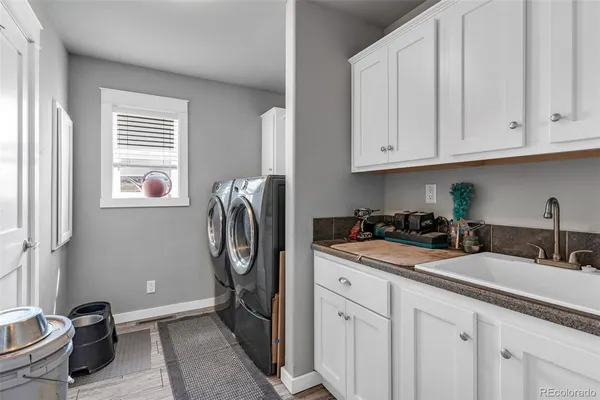 a kitchen with stainless steel appliances granite countertop a sink a stove and a refrigerator with wooden floor