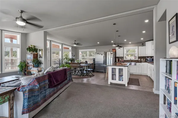 a room with lots of wooden furniture and a chandelier