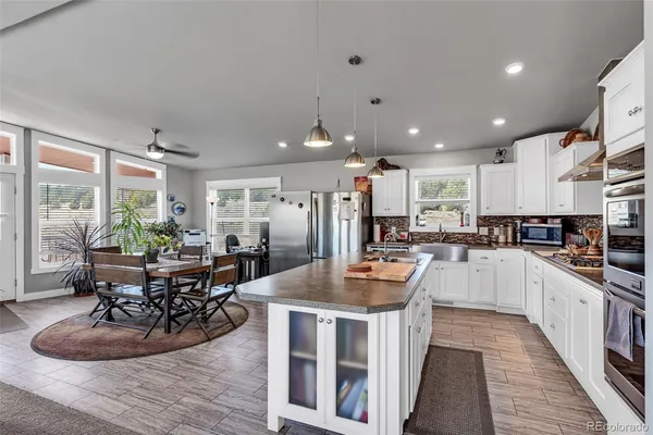 a kitchen with counter space appliances and wooden floor
